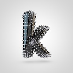 BDSM black latex letter K lowercase with chrome spikes isolated on white background