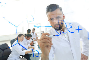 close up of a Man scientist working with formulas