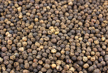 Black peppercorn seeds background. Macro shot