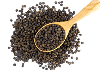 Black pepper peas on a wooden spoon  on a white background