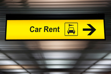 sign with arrow point to rent a car service at the airport for passenger who want to hide a car for...