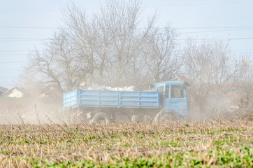 Blue truck on a dirt road 