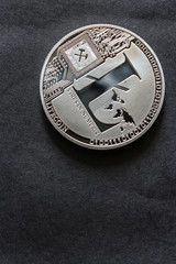 The silver litecoin. Altcoin on black table.