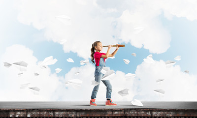 Concept of careless happy childhood with girl exploring this world