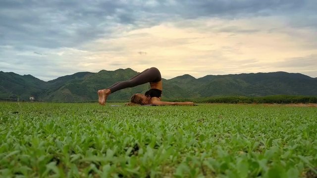 Flycam Side View Woman Holds Yoga Pose against Tropical Nature