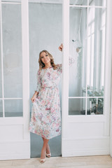 Fototapeta premium beautiful young blonde woman in nice spring dress, elegant black sunglasses posing in a studio. Fashion spring summer photo