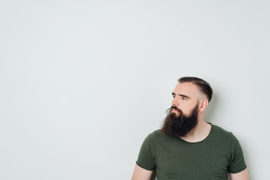 Bearded man in a green t-shirt on white