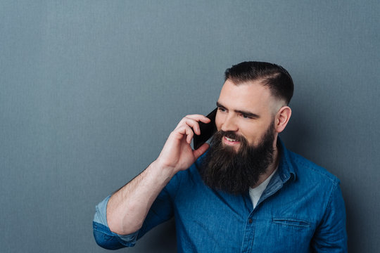 Attractive bearded man talking on his mobile