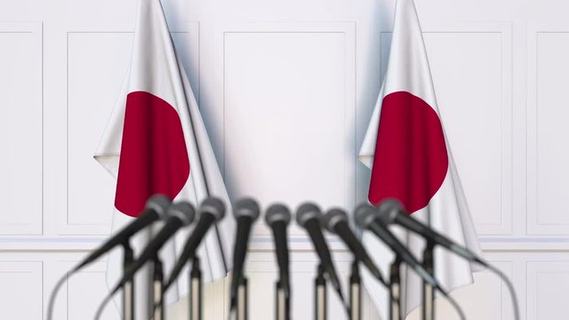 Japanese official press conference. Flags of Japan and microphones. Conceptual animation