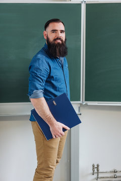 Smiling male teacher or university student