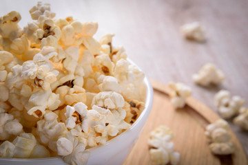 Salt popcorn on the wooden table, selective focus