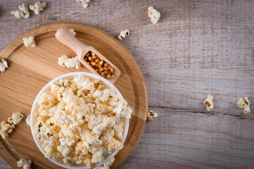 Salt popcorn on the wooden table, selective focus