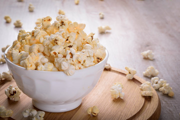 Salt popcorn on the wooden table, selective focus