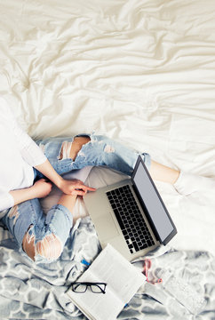 Young Pretty Woman Working With Laptop On The Bed