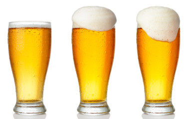 Set of a glass of cold light beer with foam isolated on white background