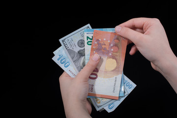 Hand holding American dollar  isolated on black background