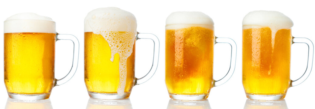 Set of mugs of cold light beer with foam isolated on white background