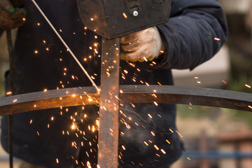 hands at work with metal welding