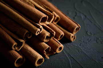  shelves of cinnamon in dark colors on a dark concrete stone background