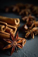  shelves of cinnamon in dark colors on a dark concrete stone background