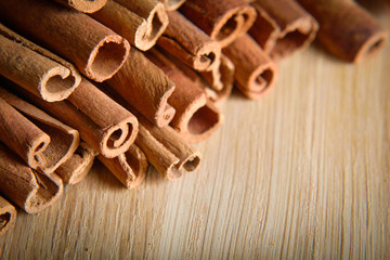  shelves of cinnamon and anise stars in dark backgrounds on a wooden background