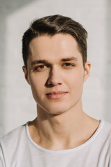 Fototapeta premium portrait of handsome man looking at camera at home