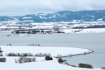 Trondheim fjord, Gaulosen nature reserve and the beach Oestrand after snowfall in the spring 