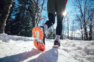  Close up of male feet running along winter road and snow