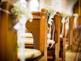 Beautiful decor of white flowers in church for a wedding ceremony in color