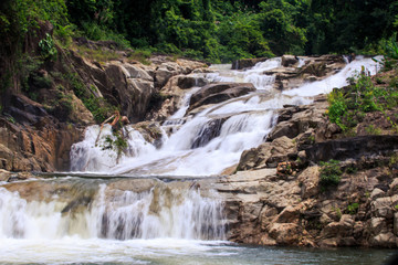 Cascade of Waterfalls in Stones among Tropical Trees