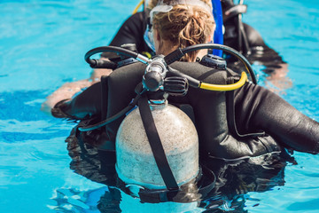 grey scuba diving air oxygen tank on the back of a scuba diver