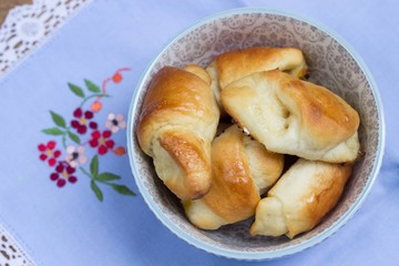 homemade yeast croissants in a bowl on the vintage napkin with embroidery