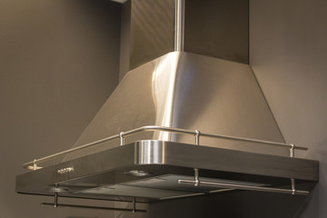 Elegant stainless steel kitchen cupboard, on a gray background