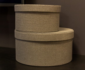 Wicker decorative boxes for storage put one on top of the other.