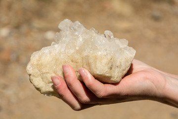 rose quartz in the natural state in one hand