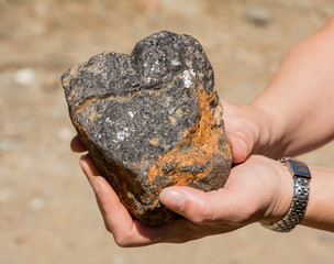 silver traces in the rock in his hand
