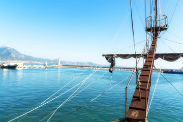 View from the bow of the ship. Coastal spit, lighthouse and mountains. Beautiful view. Journey. Turkey, Alanya