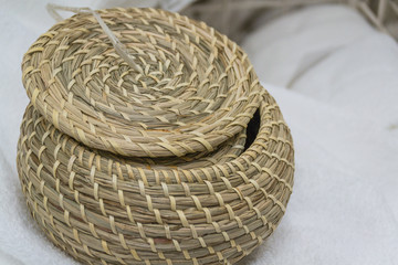 Woven storage box. A large weaving. With a lid. An object.
