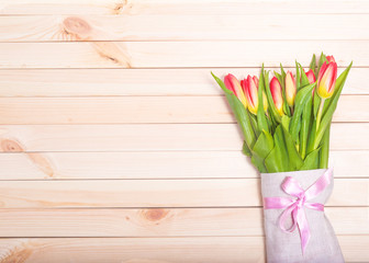 Fresh tulips on a background of light wooden boards