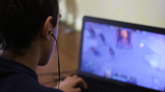 A Boy Playing A Video Game. Internet gambling addiction