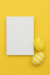 Easter holiday background. Pastel coloured decorated easter eggs with a blank white label.