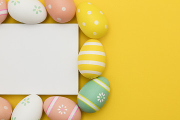 Fototapeta na wymiar Easter holiday background. Pastel coloured decorated easter eggs with a blank white label.