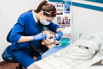 Dentist holding tooth whitening procedure