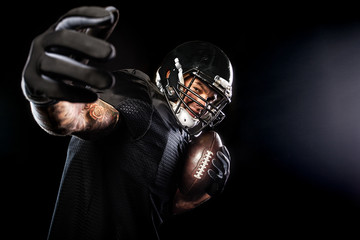Fototapeta na wymiar American football sportsman player isolated on black background