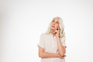 Portrait of a pensive mature woman standing with arms folded