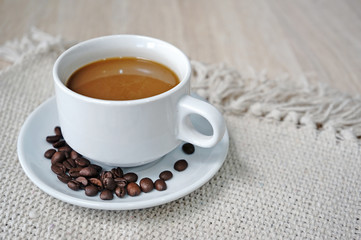 Hot cappuccino with coffee bean on wooden table 