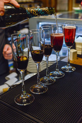 Wine pouring into the glasses on bar