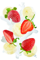 Flying strawberries and banana slices with a spray of milk