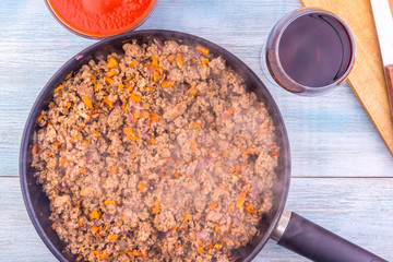 Fried minced meat on a frying pan close-up