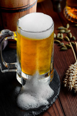 Light foam beer in a glass on an old background
